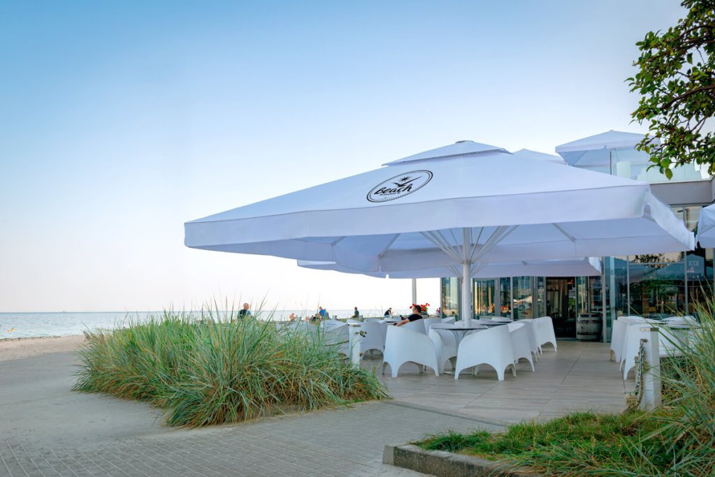 Large commercial parasols at a seaside hospitality venue