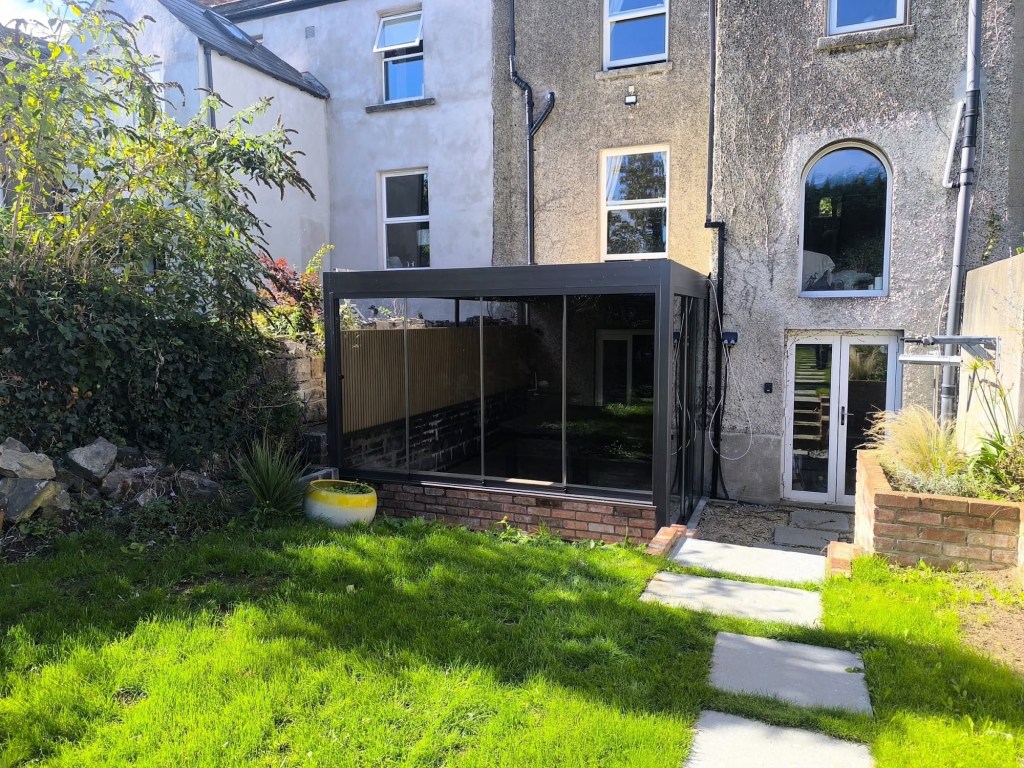 Glass-walled pergola garden room in an Irish back garden