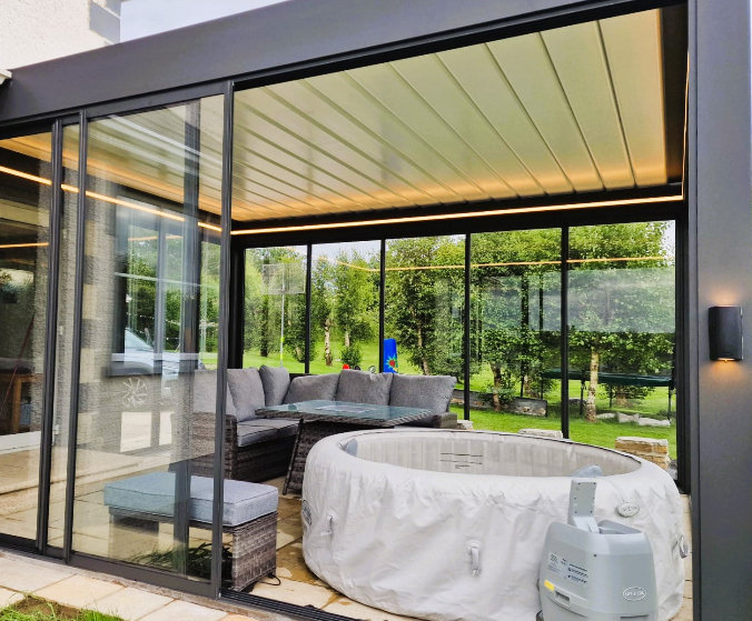 Glazed louvred pergola outdoor living room with LED lighting