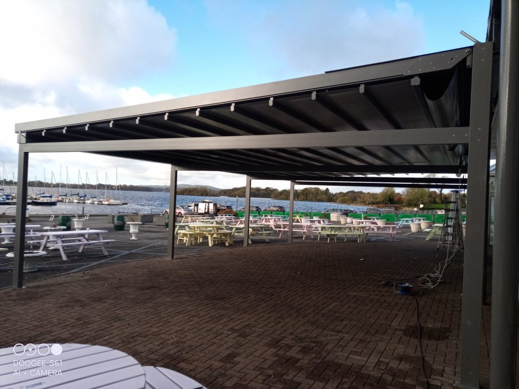 Large commercial pergola over a waterside hospitality terrace