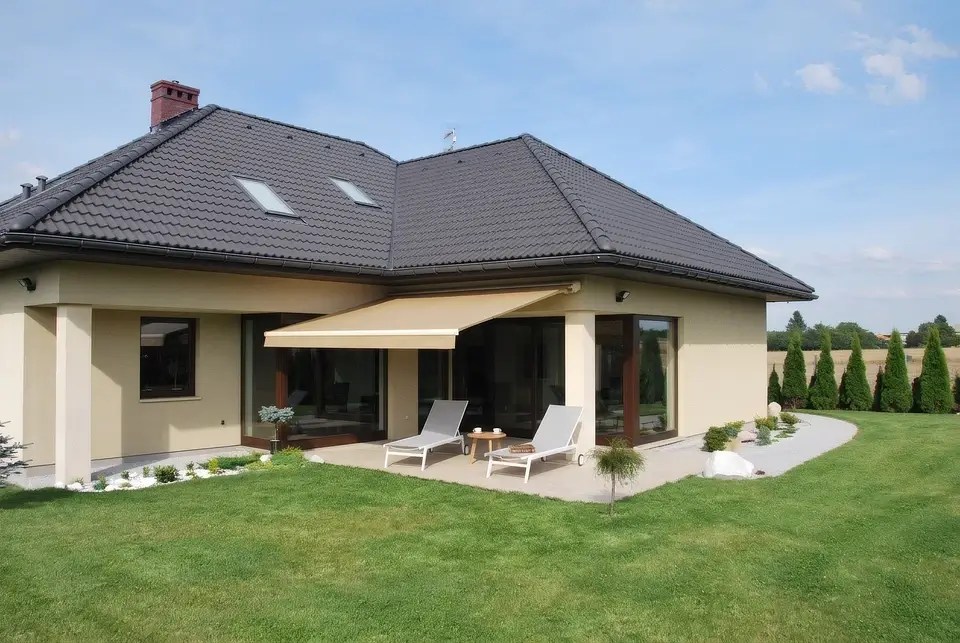 Awning shading the terrace and patio doors of a family house