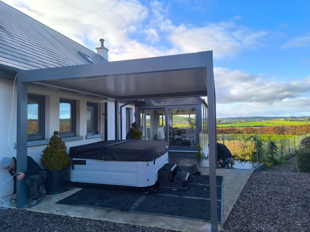 Pergola with glass sides covering a hot tub with countryside views