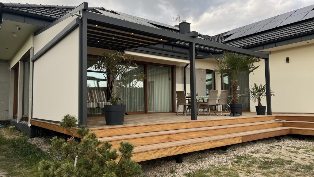 Wall-mounted retractable pergola over a timber deck